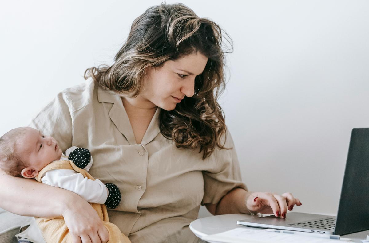 Parent helping child set up their first email account with safety settings