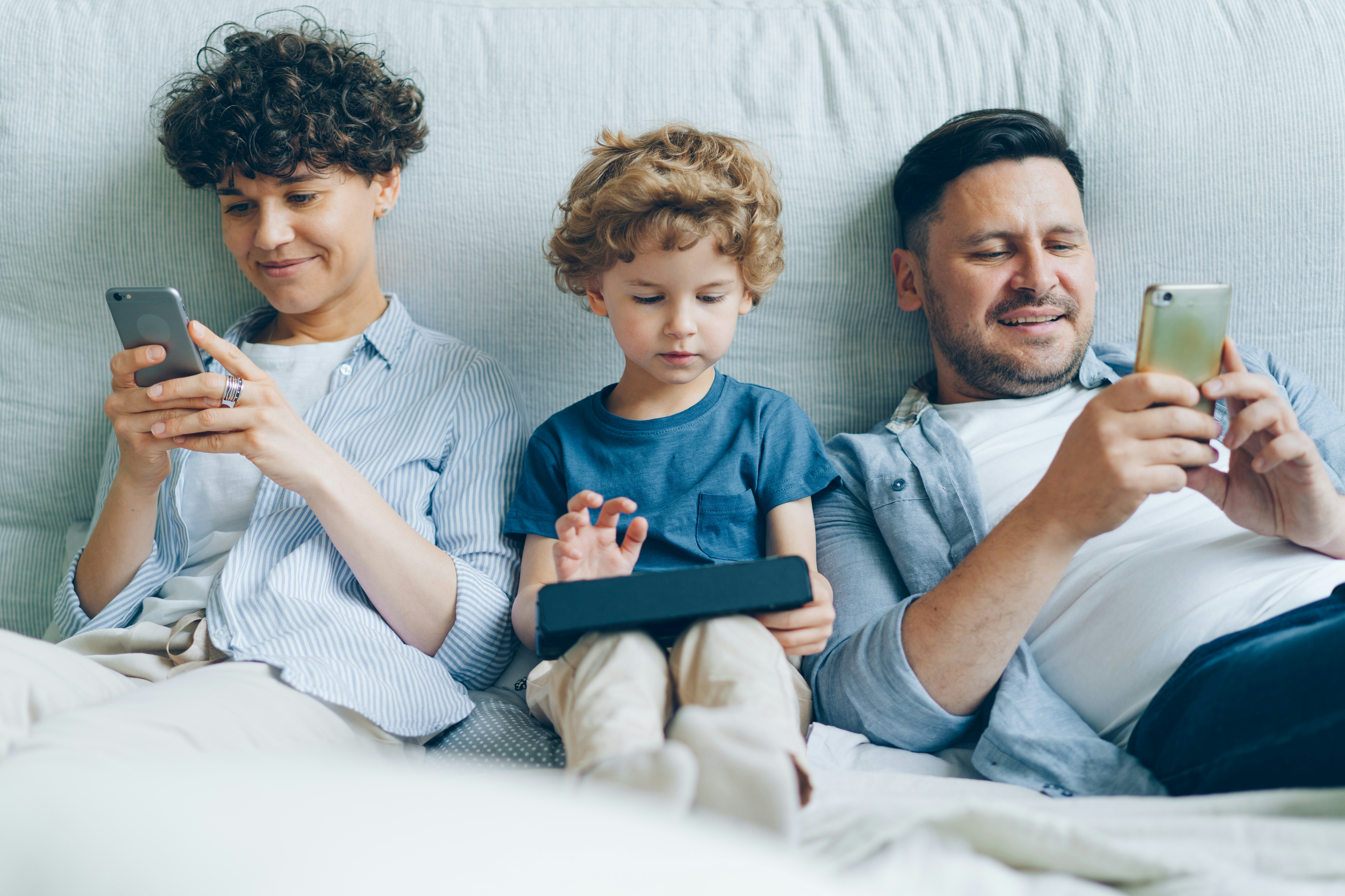 Family using digital devices together